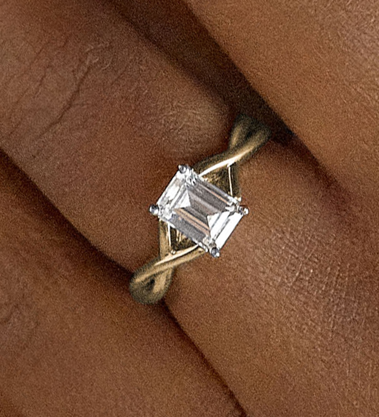 An emerald cut engagement ring with a twisted band