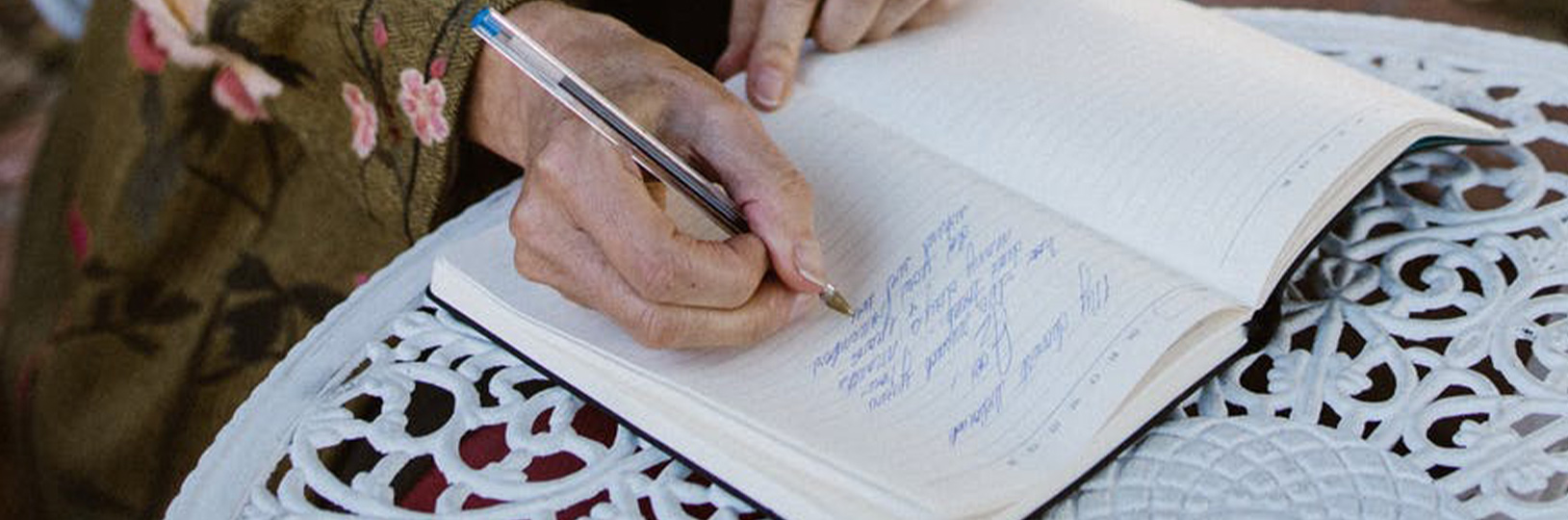 Image of a person writing their wedding vows