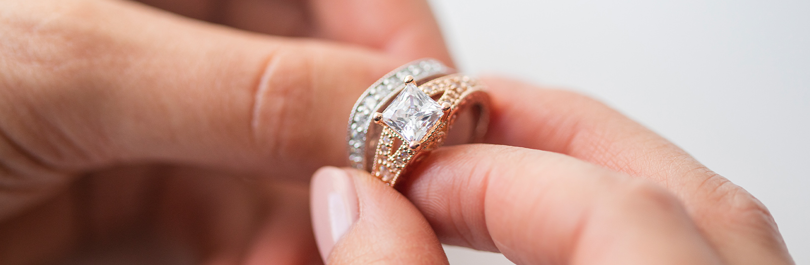 A Princess cut engagement ring paired with a silver accented wedding band