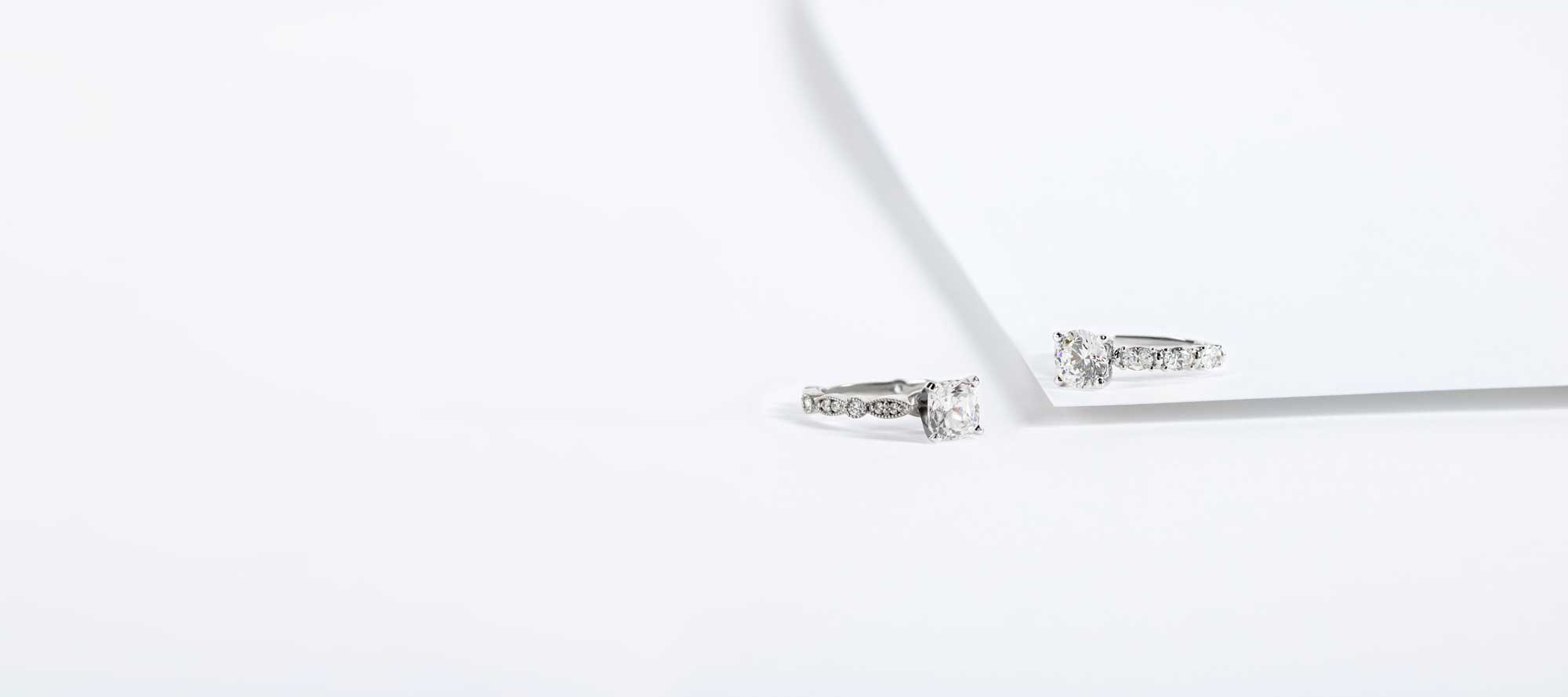 Cushion cut engagement ring and round cut engagement ring side by side