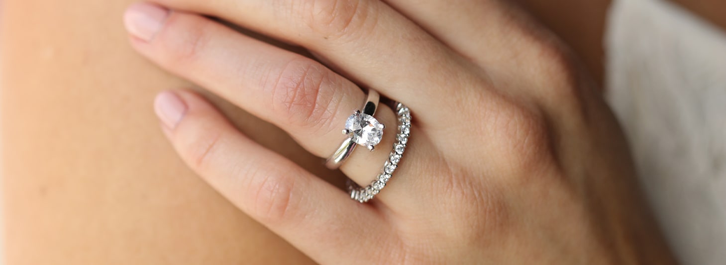 An oval cut stone paired with an accented wedding band